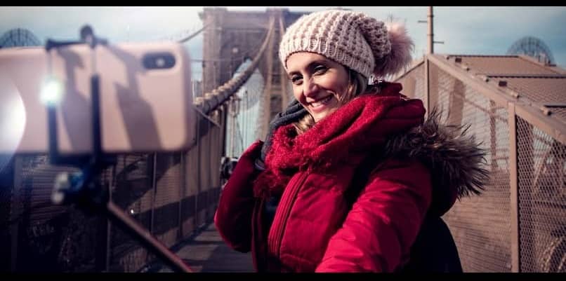 mujer fotografiando a sí misma con un selfie stick